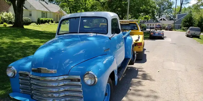 Classic car towing Nashville — vintage vehicle on enclosed flatbed tow truck for damage-free transport