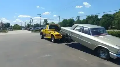 Ford Galaxie on a wheel-lift tow truck in Nashville