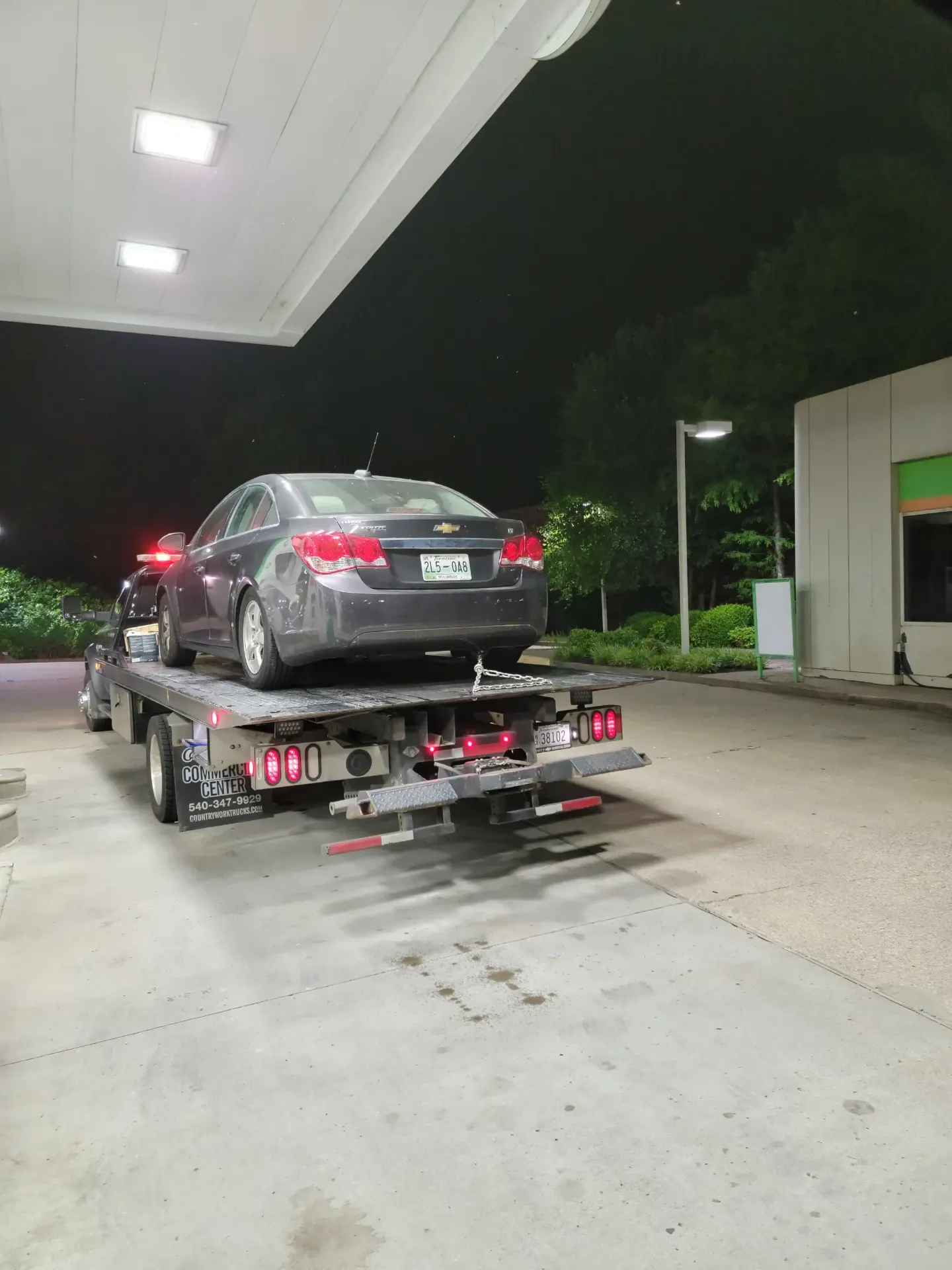 Chevy Cruze loaded at a Nashville gas station at night