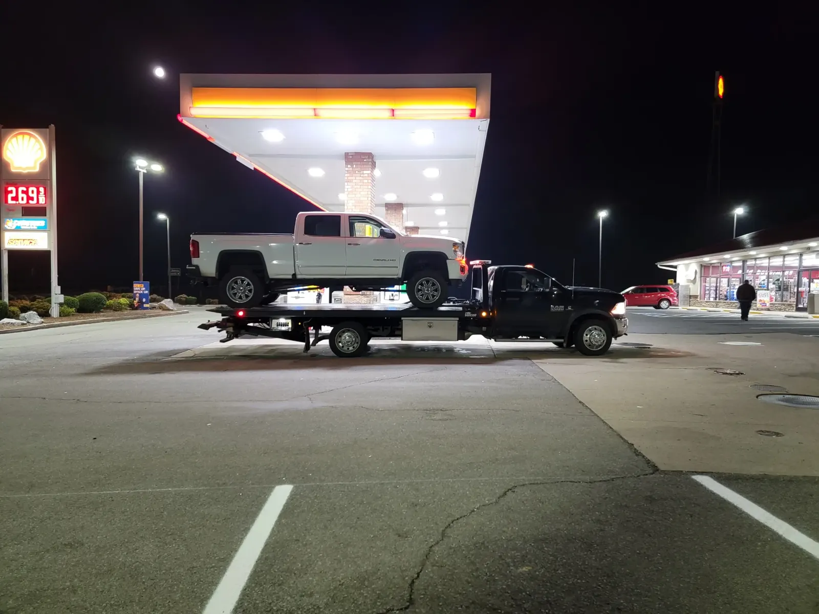 GMC Denali towed from a gas station at night in Nashville