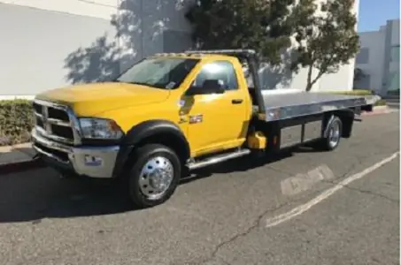 Dodge vehicle being towed on flatbed truck - Nashville towing pricing guide