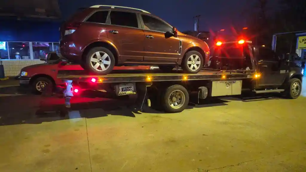 Hook Em' Up Towing flatbed loading an SUV after a Bellevue TN nighttime breakdown