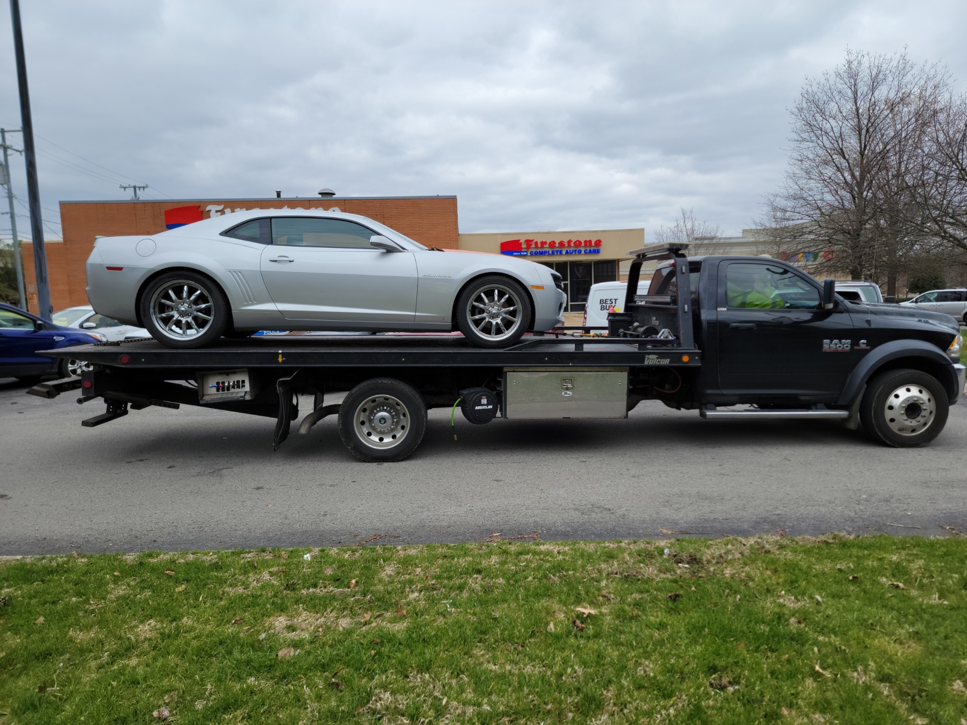 Sports car on flatbed tow truck - comparing roadside assistance vs towing service Nashville